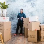 A man surrounded by moving boxes