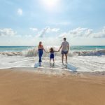 a family of three at the beach