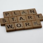 scrabble tiles that spell the quote "plan, start, work"