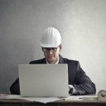 a man wearing a hard hat researching the permits for home renovation in Orange County