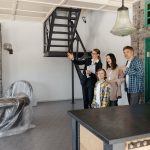 parents and a child exploring their new home with an agent