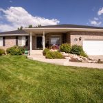 a beautiful house with a big, green lawn