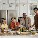 a big family smiling in their kitchen