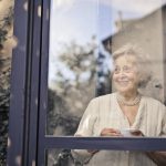 an elderly lady looking through the window