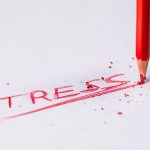 the word "stress" written in red letters