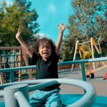 a little girl playing in a park which is one of the free activities for kids in Irvine CA