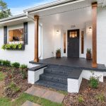 a comfortable house with a black front door and white walls