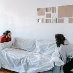 Couple getting ready for moving heavy items in heavy rain